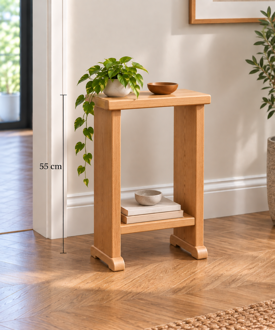 55 cm: Handmade solid oak side table, 55cm high, with lower shelf and rounded feet, displayed in a modern home interior.