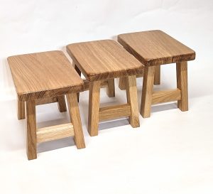 Solid oak milking stool with gently shaped wooden seat